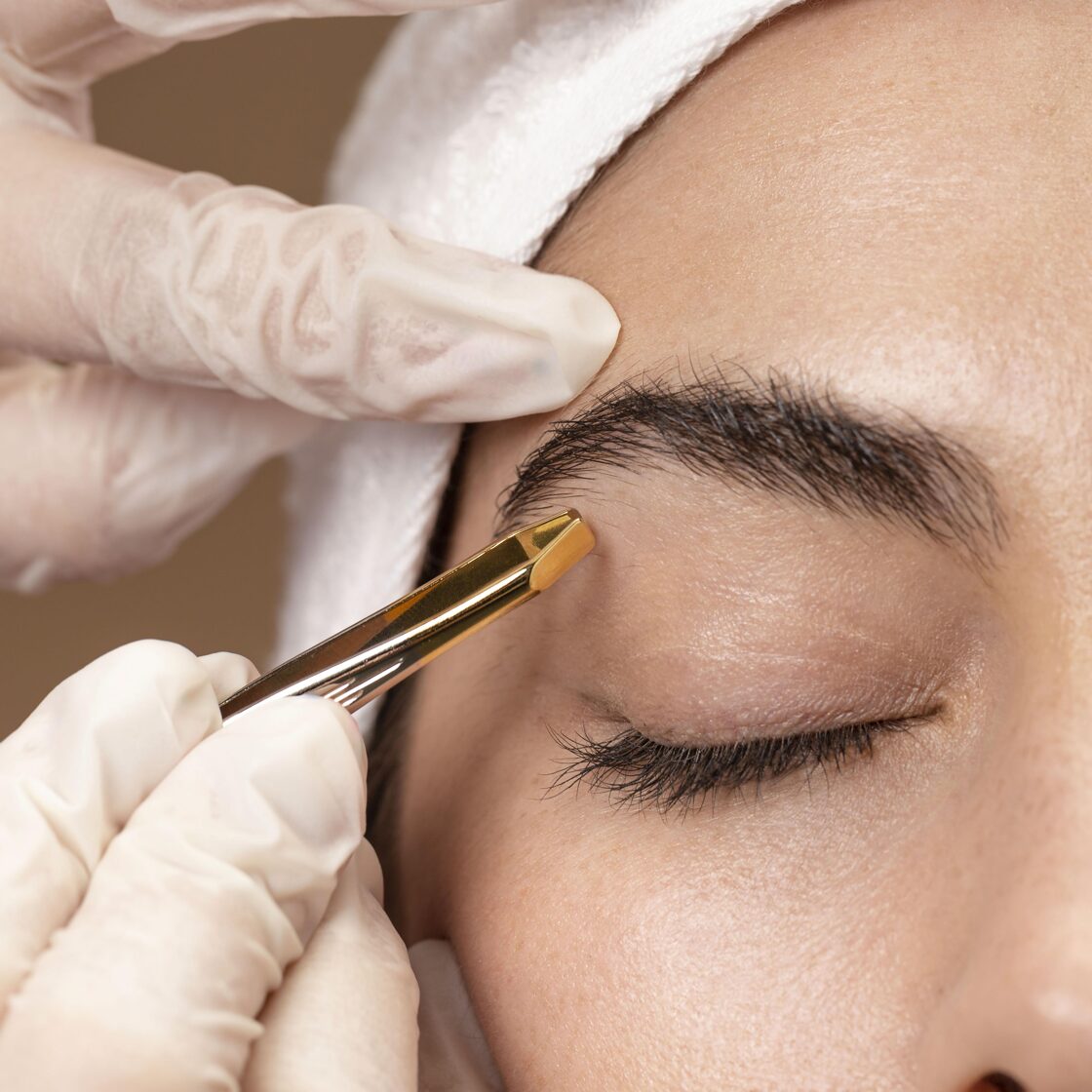 woman-doing-eyebrow-treatment-her-client.jpg